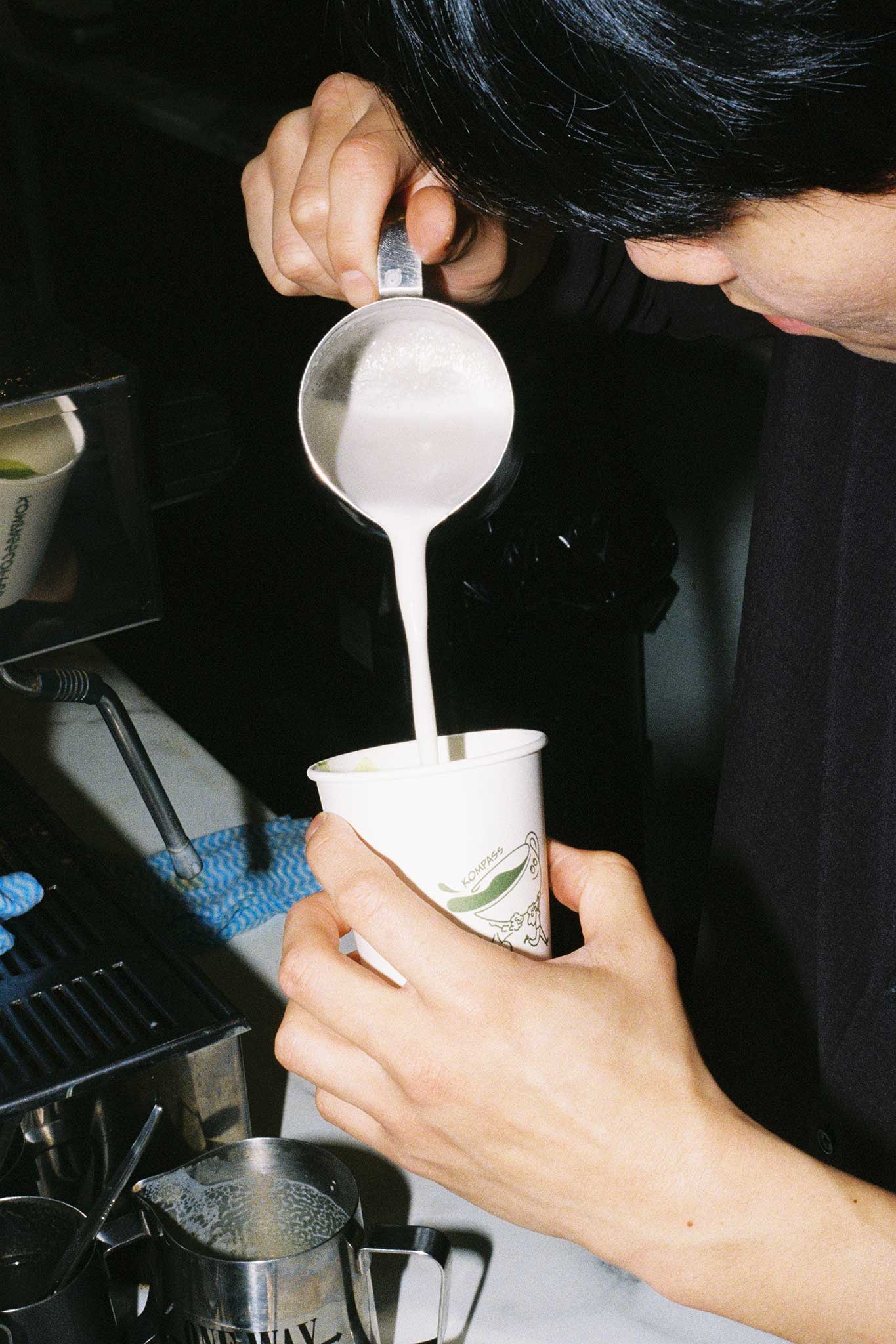 Barista behind the bar making matcha. 35mm aesthetic brand social media imagery for cafés.